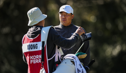 Norman Xiong speaks to his caddie during PGA Tour Q-School