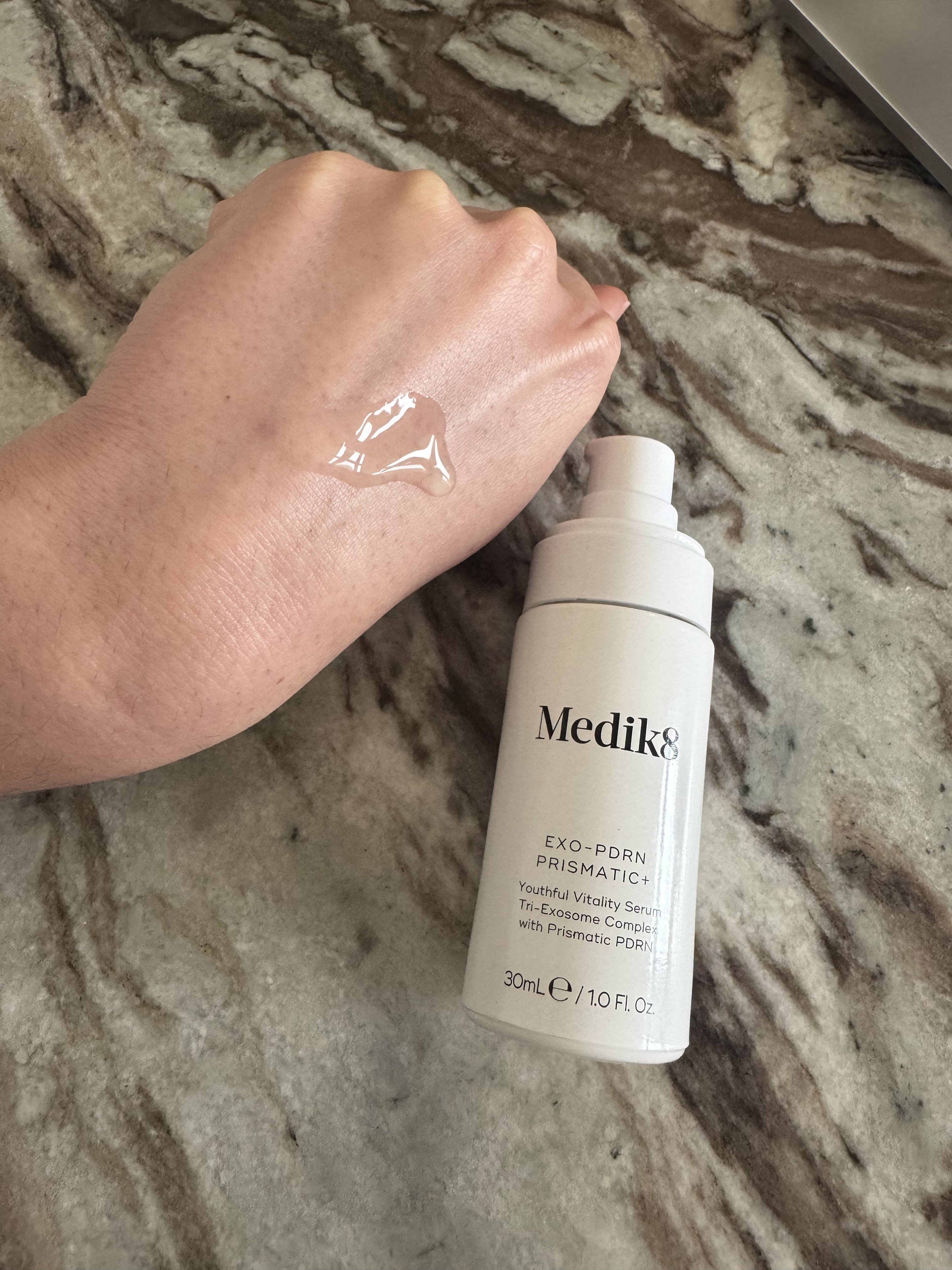 Eleanor pumping the medik8 serum onto the back of her hand, which has a runny gel texture