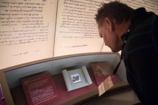Visitors look at an exhibit about the Dead Sea scrolls at the Museum of the Bible in Washington, D.C. 