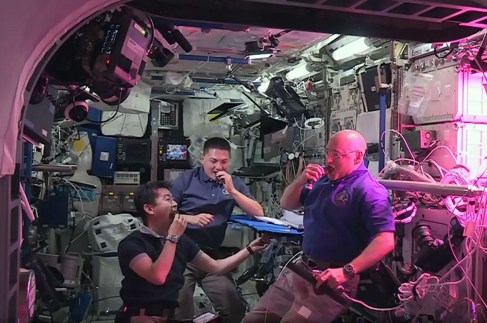 NASA astronauts Scott Kelly (left) and Kjell Lindgren (center) with Kimiya Yui of JAXA snack on freshly harvested space-grown red romaine lettuce as part of the Veggie experiment. 