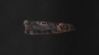 One side view of 1800 year-old iron knife with ornamental design possibly inspired by Roman designs.