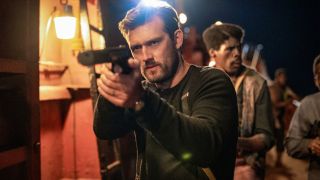 Alex Pettyfer leading a night time raid gun drawn in The Ministry of Ungentlemanly Warfare.