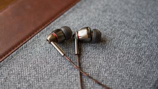 1MORE Quad Driver headphones on cloth surface