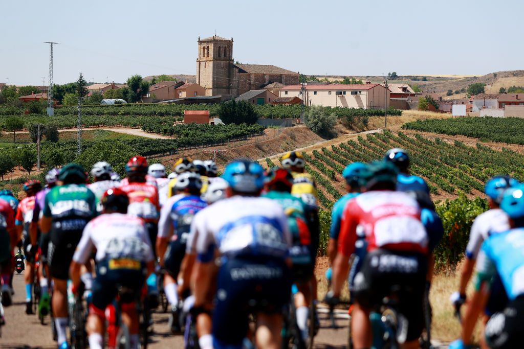 CLUNIA SPAIN AUGUST 05 A general view of the peloton passing through village landscape during the 44th Vuelta a Burgos 2022 Stage 4 a 169km stage from Torresandino to Ciudad Romana de Clunia VueltaBurgos on August 05 2022 in Clunia Spain Photo by Gonzalo Arroyo MorenoGetty Images