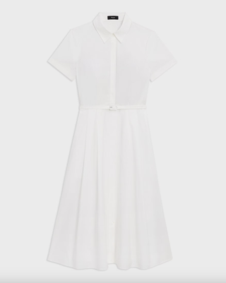 a white button down theory dress in front of a plain backdrop
