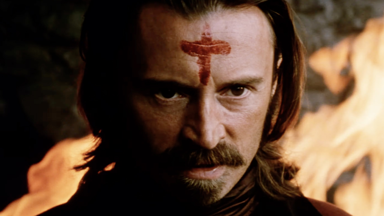 Robert Carlyle with a goatee and blood cross on forehead, staring in The Ravenous 1999.