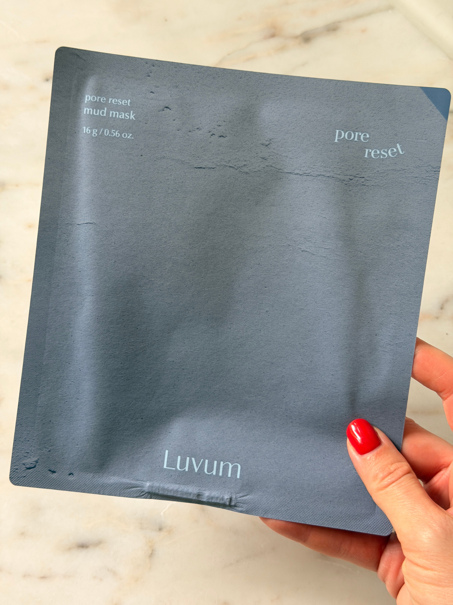 Freelance beauty editor Grace Day holding the Luvum face mask