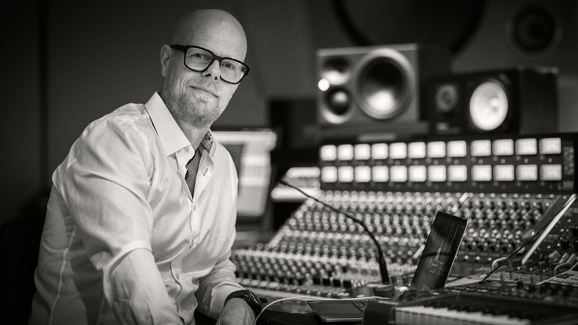 man sitting next to mixing desk