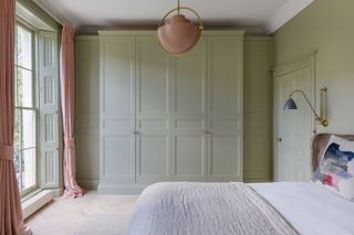 a bedroom painted in all sage green