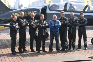 Former NASA astronaut Scott Kelly poses for a photo with the Breitling Jet Team on the deck of the Intrepid Sea, Air and Space Museum in New York City on May 26, 2016 during Fleet Week celebrations.