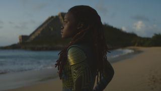 Nakia stands on a beach and looks out onto the ocean in Black Panther: Wakanda Forever