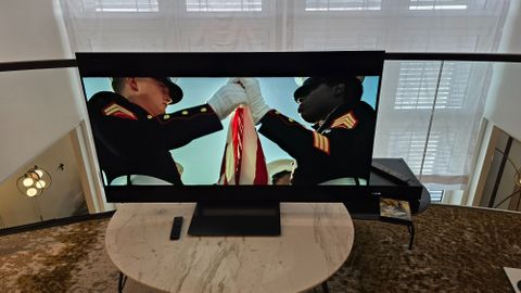 Samsung S90D 48-inch TV on a marble table with Top Gun Maverick playing on screen 