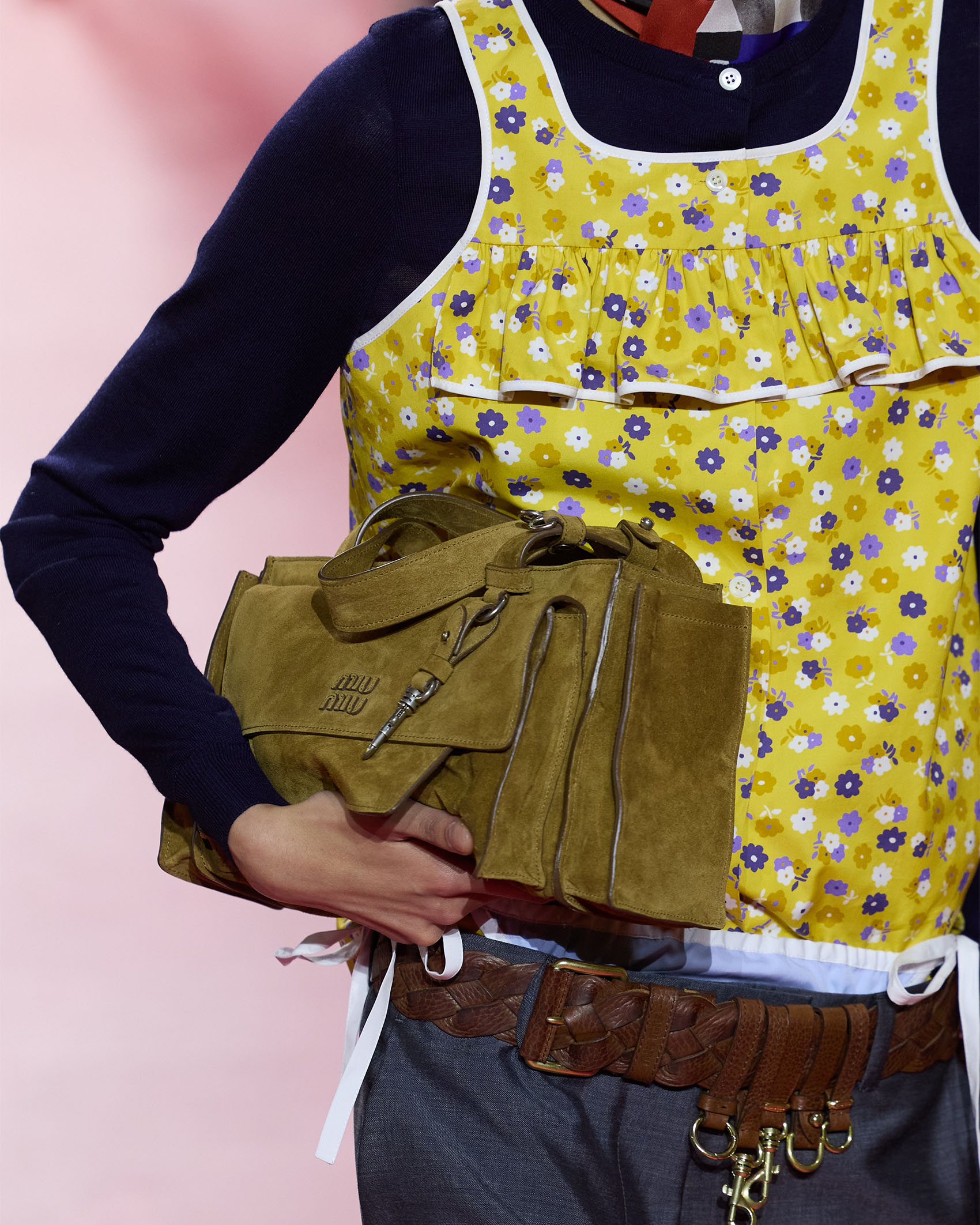 model holding a Miu Miu bag on the runway