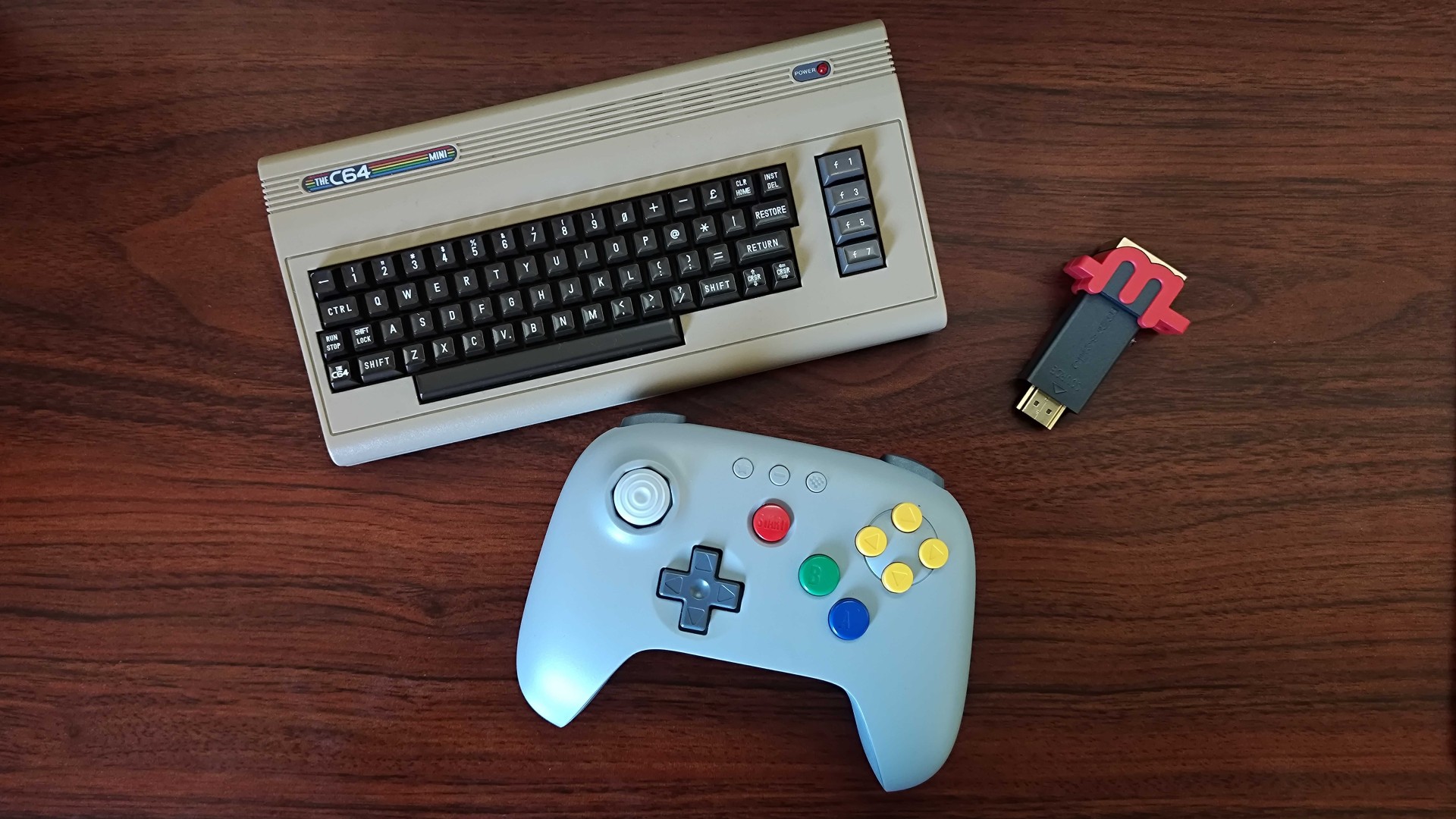 C64 Mini, 8BitDo 64 controller, and mClassic retro upscaler on a wooden desk