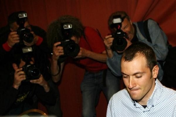 Ivan Basso surrounded by photographers