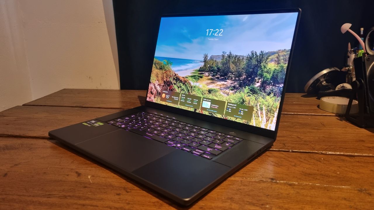The Asus ROG Zephyrus G16 sitting open on a wooden desk