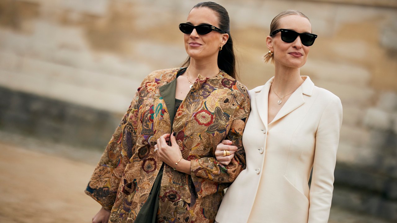 Two guests at Paris fashion week Fall 2024 wearing black sunglasses