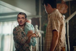 Rowan Atkinson as Trevor holding a baby in Man vs Baby