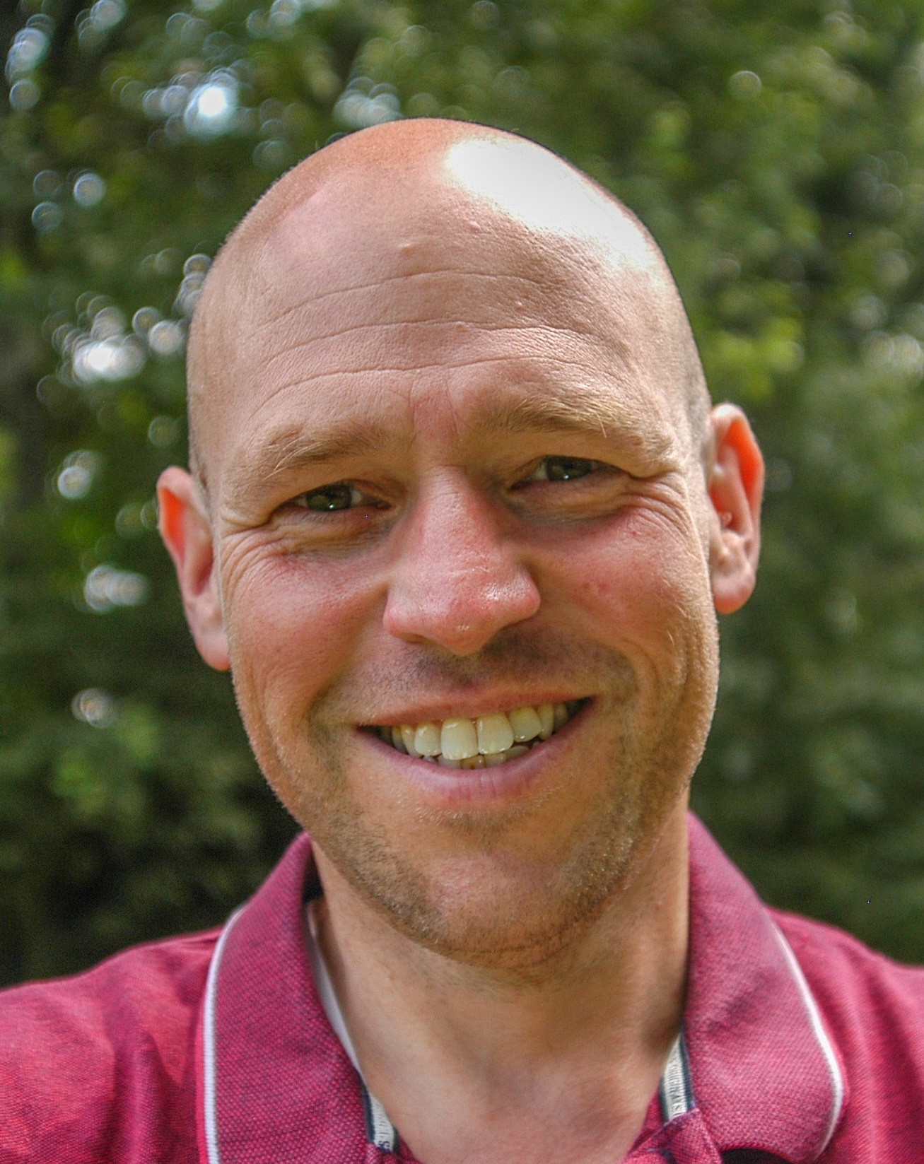Smiling headshot of Ronny Van Geel.