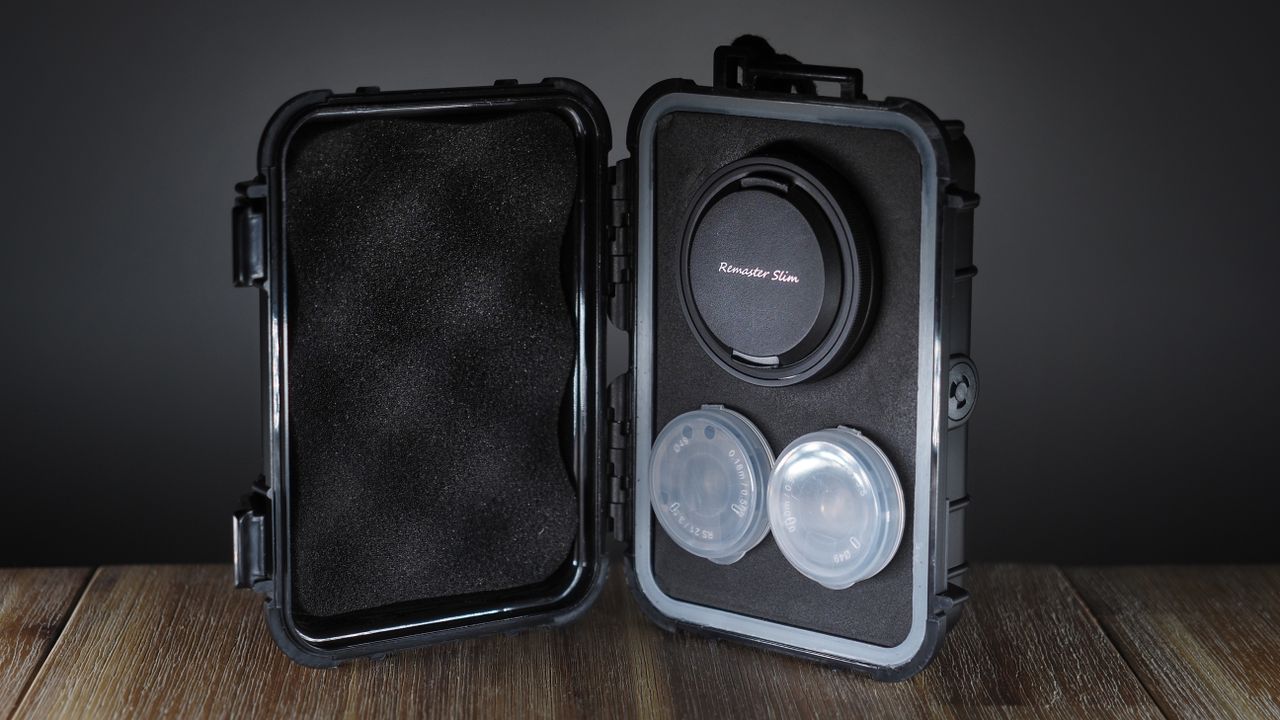 Samyang Remaster Slim hard case with module and lenses on a wooden surface
