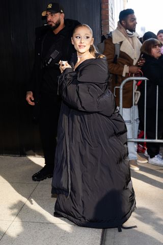 Ariana Grande is seen in Midtown on December 03, 2024 in New York City wearing a long puffer coat