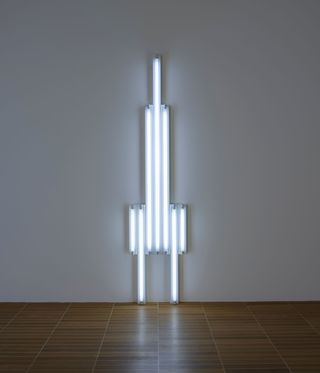 tall neon light sculpture by Dan Flavin in gallery