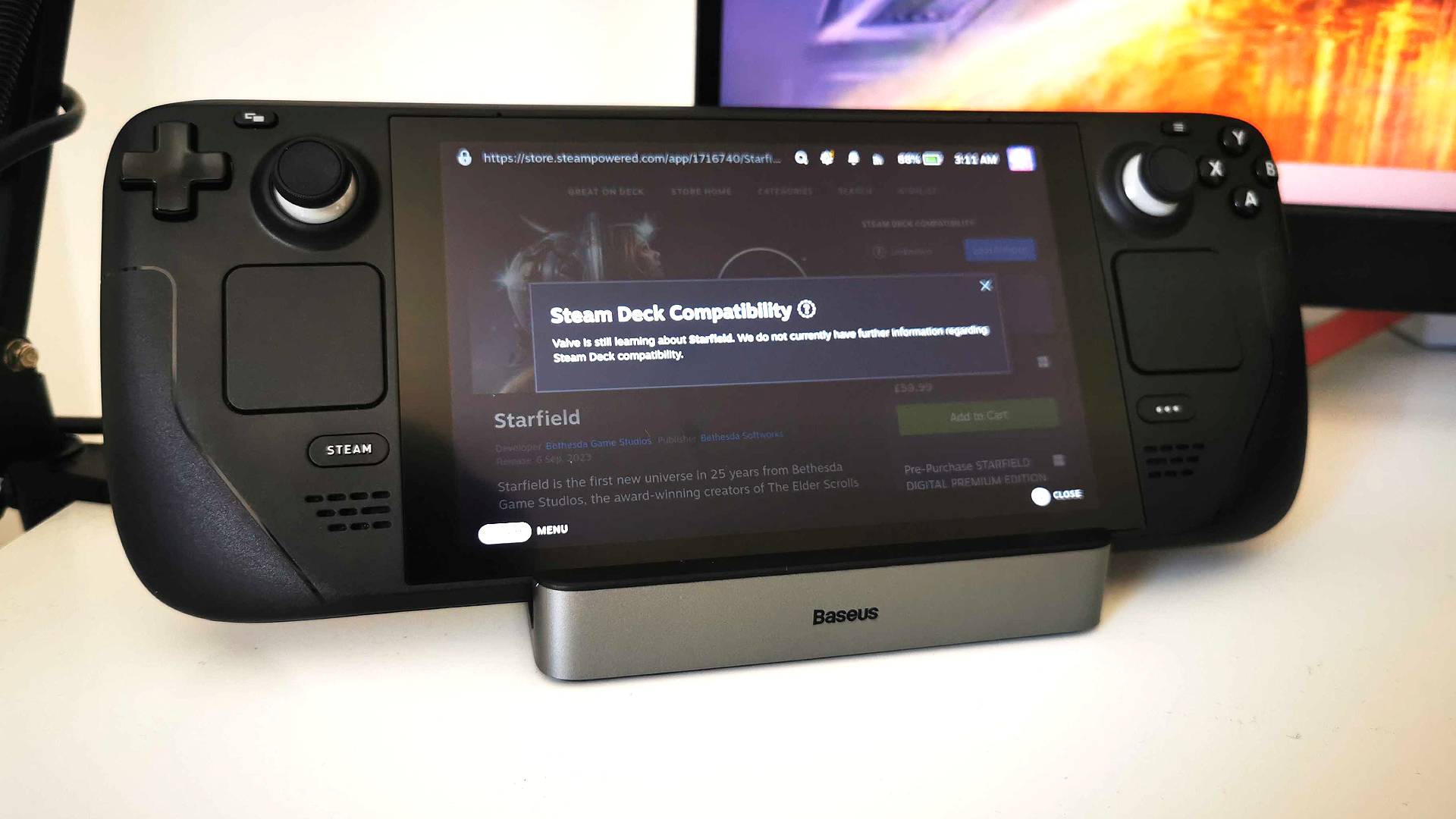 Steam Deck sitting on Baesus docking station with Starfield compatibility information on screen