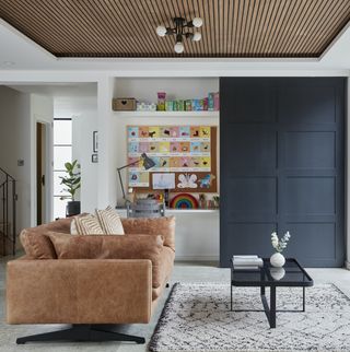 Living area with leather sofa , wooden ceiling and white rug