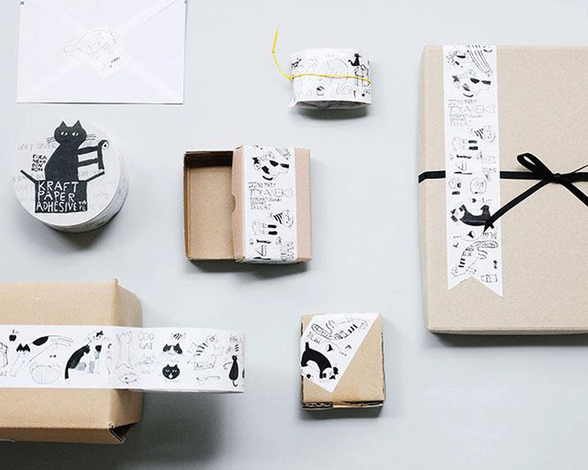 Simple gift wrap idea with neutral packages, black twine, and washi tape strips.
