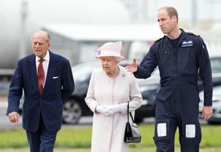 Prince William, Duke of Cambridge gives his grandparents Queen Elizabeth II and Prince Philip, Duke of Edinburgh a tour as they open the new East Anglian Air Ambulance base