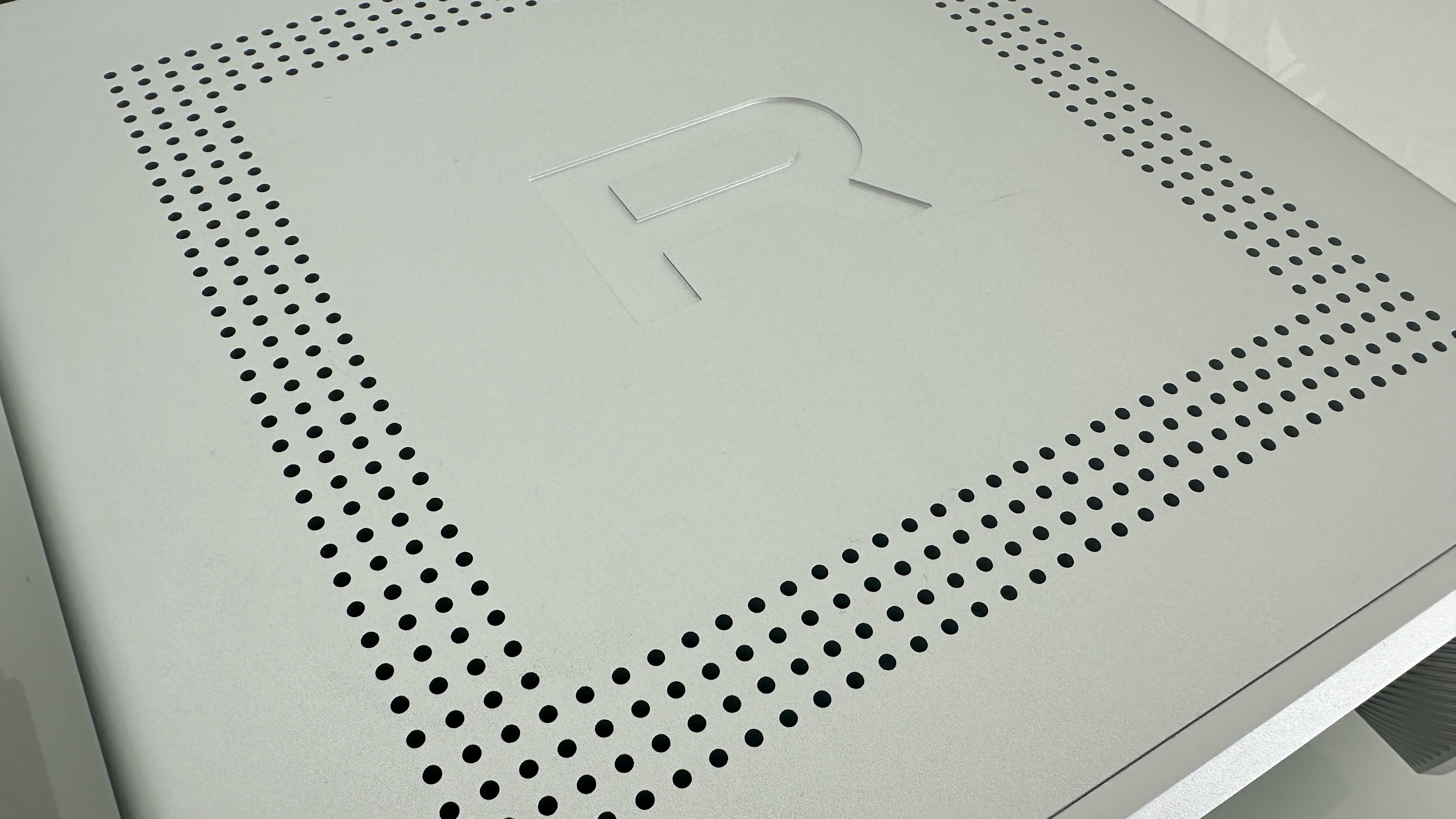 Rotel's DX-5 integrated amp in silver on a light gray table, with the amp's remote visible