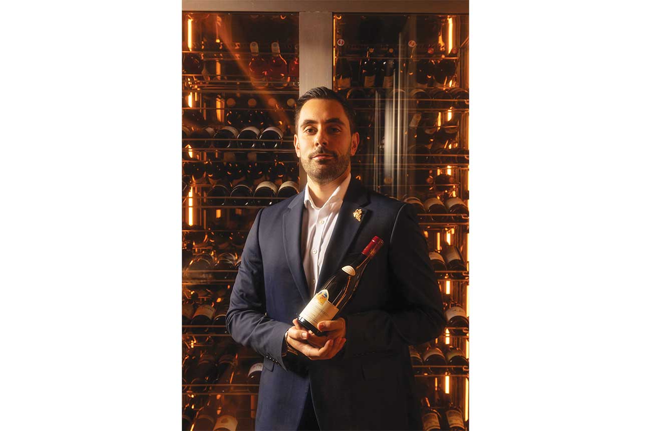 Alessio Ragusini holding bottle of wine