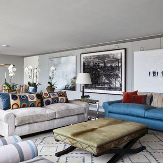 living area with blue sofa and wooden flooring
