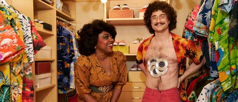 Quinta Brunson watches as Daniel Radcliffe shows off his gold records in Weird: The Al Yankovic Story.