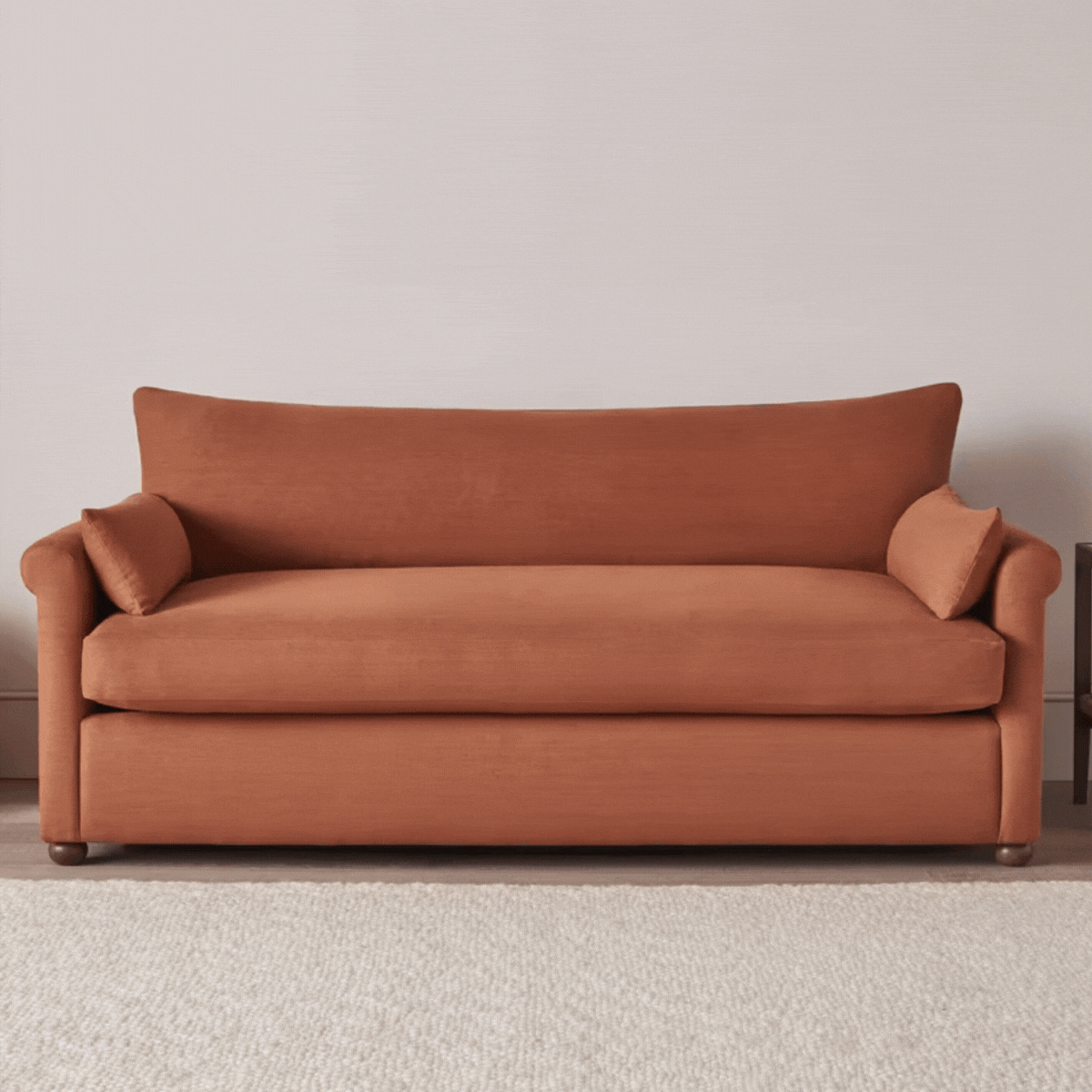 A terracotta-colored sofa bed
