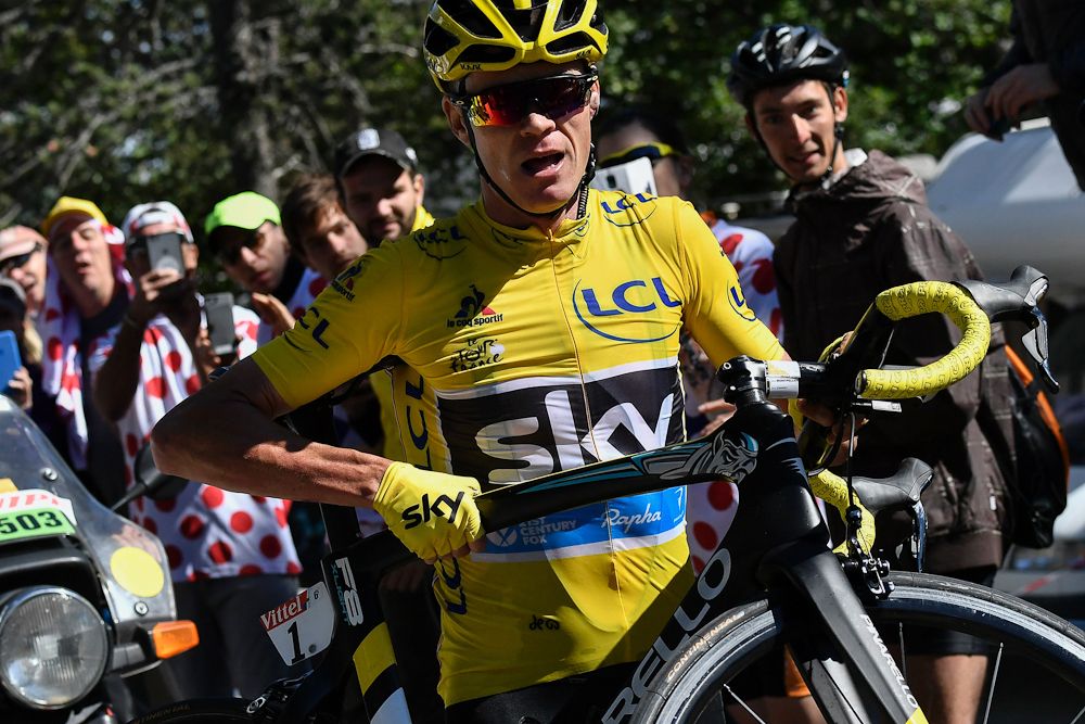 Chrtis Froome looks for his team car after his bike was damaged in a crash