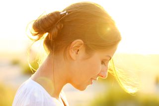 A woman sits in the sunshine