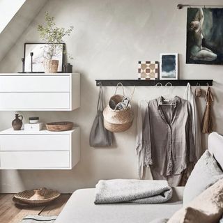 bedroom with wooden flooring and wall mounted clothes hanger