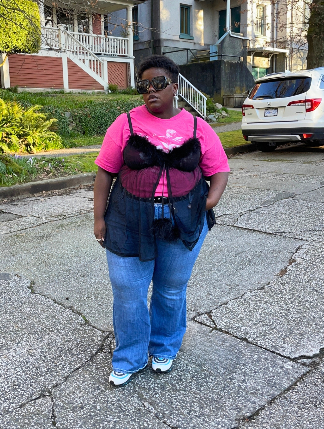 Lydia Okello styles a Y2K look with a lace babydoll top over a neon pink tee
