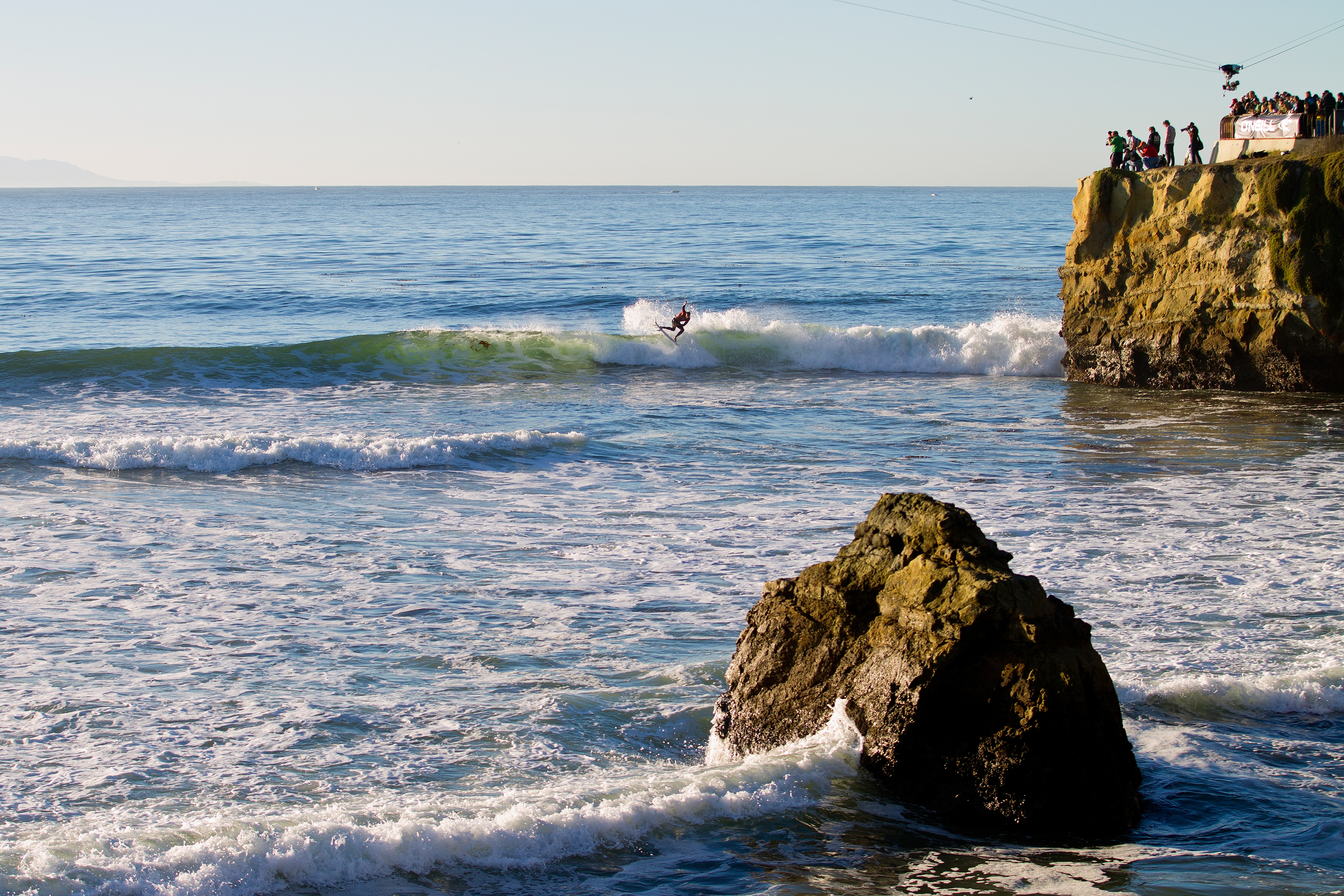A man surfs off the coast of Santa Cruz, California