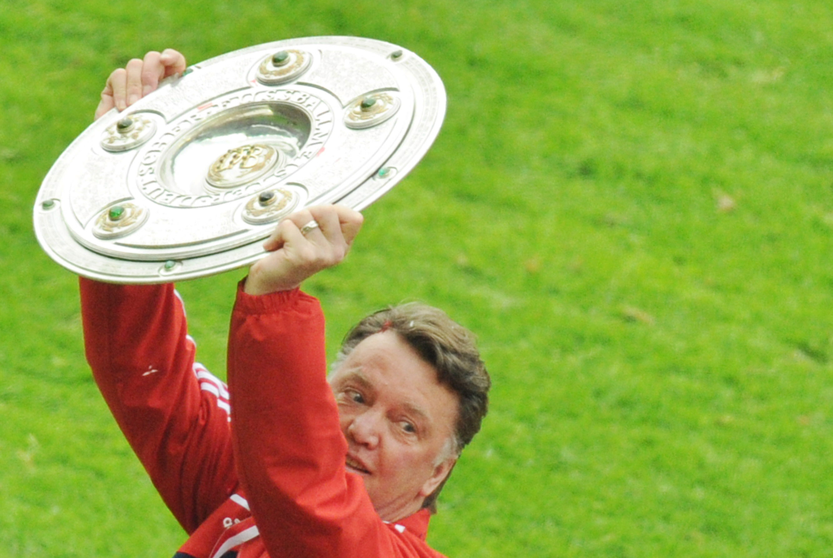 Louis van Gaal celebrates with the Bundesliga trophy after Bayern Munich's title win in May 2010.