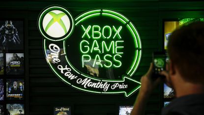 Man photographing the Xbox Game Pass neon sign at E3 2018