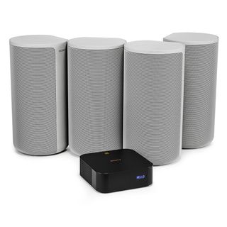 A Sony HT-A9 home theatre system. It is made up of four grey rectangular speakers, with a small black box in front of them. The background is white.