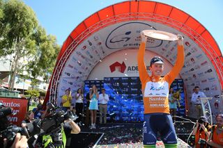 Simon Gerrans holds his fourth Tour Down Under trophy aloft