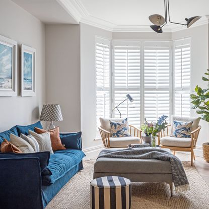 A blue sofa and bay window in a modern family home