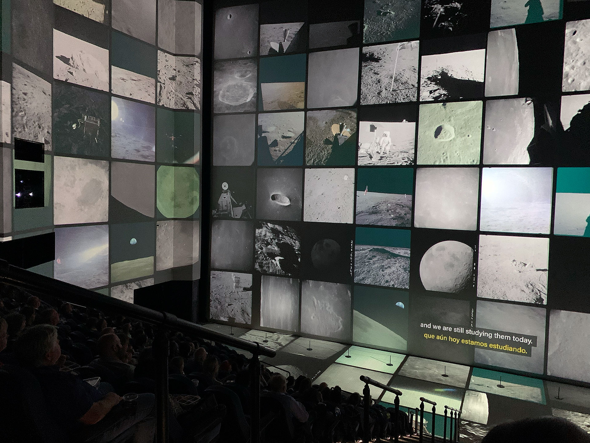 hundreds of photos taken of the moon by astronauts are projected onto a giant movie screen, as well as the theater's walls and floor