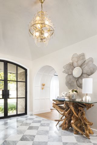 hallway with tall vaulted ceilings and chandelier