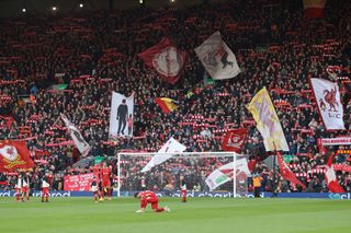 flags wave on the Kop as the fans sing 'you'll never walk alone' prior to the Premier League match between Liverpool FC and Ipswich Town FC at Anfield on January 25, 2025 in Liverpool, England.