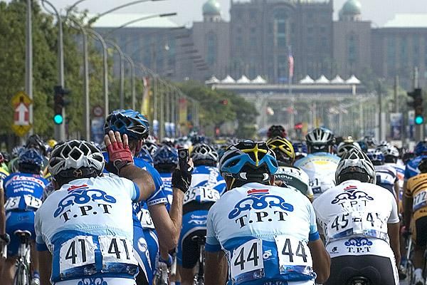 Ghader Mizbani (41) of the Tabriz Petrochemical Cycling Team waves to the camera held by a Giant Asia rider just after the start in Putrajaya.
