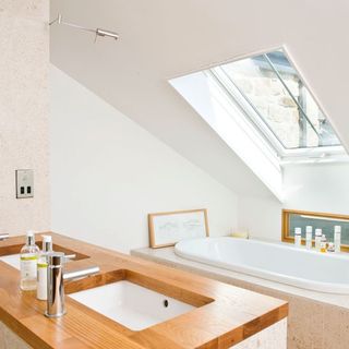 bathroom with white basin and bathtub